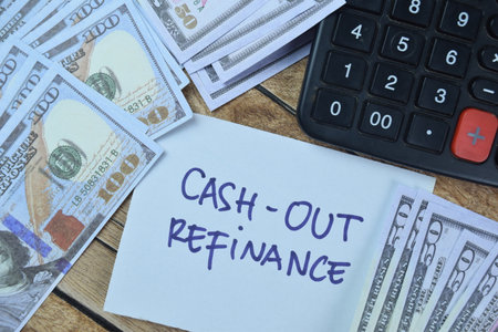 Concept of Cash-Out Refinance write on sticky notes with dollar isolated on Wooden Table.