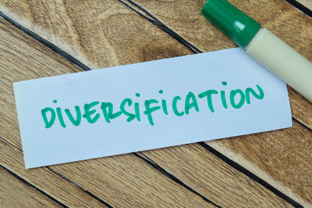 Concept of Diversification write on sticky notes isolated on Wooden Table.の写真素材