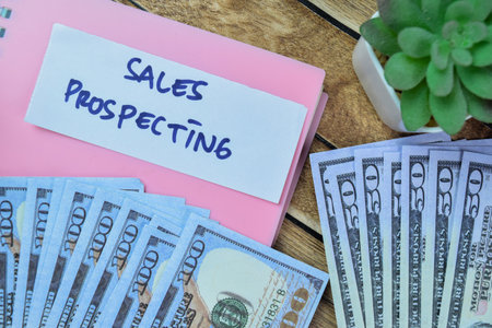 Concept of Sales Prospecting write on sticky notes with dollar isolated on Wooden Table.の写真素材