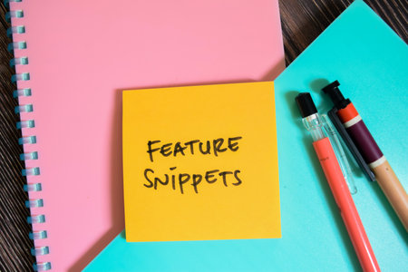 Concept of Feature Snippets write on sticky notes isolated on Wooden Table.