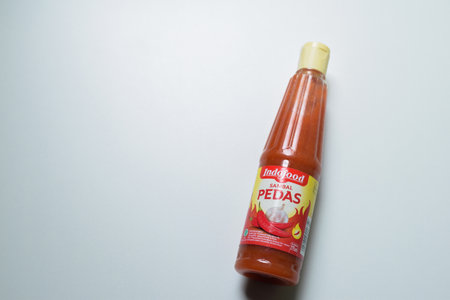 A bottles of hot chili sauce in the white background, saus indofood extra pedas. Bekasi, Indonesia,...