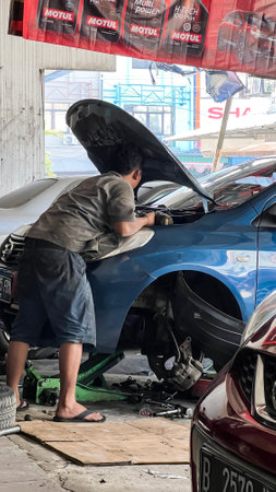 Car care maintenance and servicing, Close-up hand technician auto mechanic using the wrench to repairing. Bekasi, Indonesia, November 20, 2023のeditorial素材