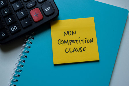 Concept of Non Competition Clause write on sticky notes isolated on Wooden Table.の写真素材