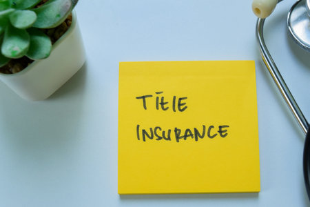 Concept of Title Insurance write on sticky notes with stethoscope isolated on white background.の写真素材