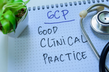 Concept of GCP - Good Clinical Practice write on book with stethoscope isolated on white background.の写真素材