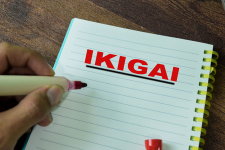 Concept of IKIGAI write on book isolated on Wooden Table.の写真素材