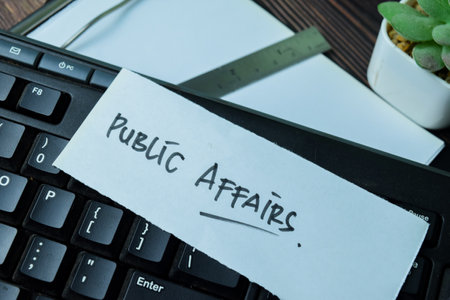 Concept of Public Affairs write on sticky notes isolated on Wooden Table.の写真素材