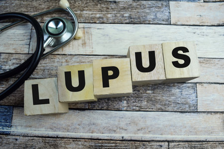 Concept of The wooden Cubes with the word Lupus on wooden background.の写真素材