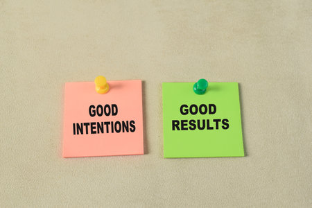 Concept of Good Intentions or Good Results write on sticky notes isolated on Wooden Table.