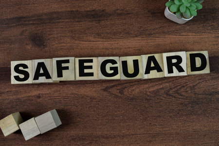 Concept of The wooden Cubes with the word Safeguard on wooden background.