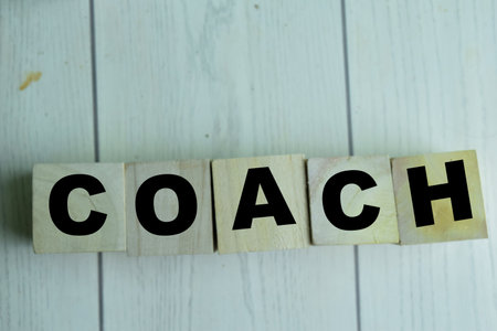Concept of The wooden Cubes with the word Coach on wooden background.の写真素材