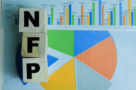 Concept of The wooden Cubes with the word NFP - Non Farm Payrolls on wooden background.の写真素材