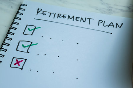 Concept of Retirement Plan write on book. Supported by an additional services isolated on Wooden Table.の写真素材