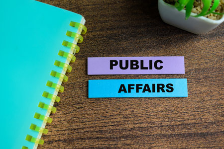 Concept of Public Affairs write on sticky notes isolated on Wooden Table.