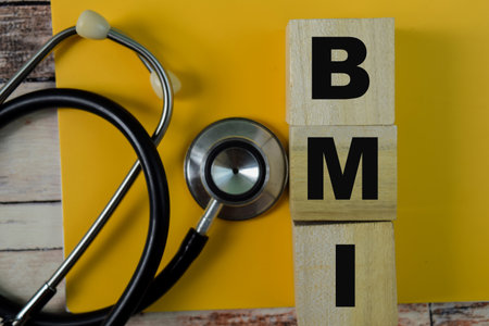 Concept of The wooden Cubes with the word BMI - Body Mass Index on wooden background.の写真素材