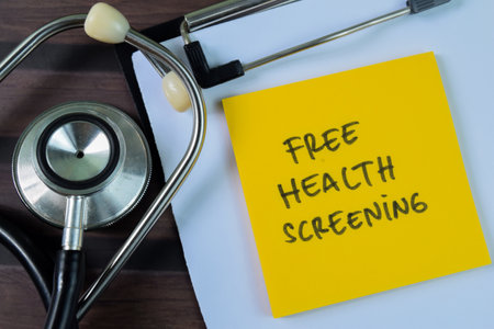 Concept of Free Health Screening write on sticky notes isolated on Wooden Table.の写真素材