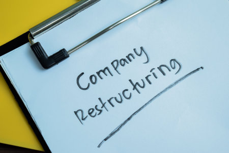 Concept of Company Restructuring write on paperwork isolated on wooden background.の写真素材