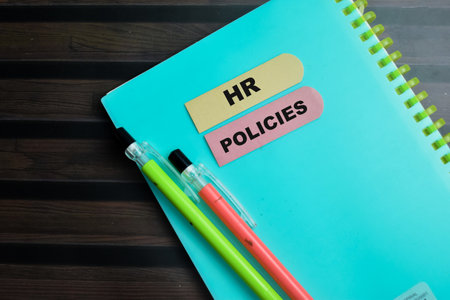Concept of HR Policies write on sticky notes isolated on Wooden Table.の写真素材