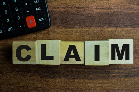 Concept of The wooden Cubes with the word Claim on wooden background.の写真素材