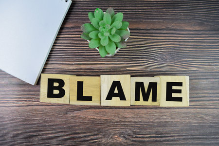 Concept of The wooden Cubes with the word Blame on wooden background.の写真素材