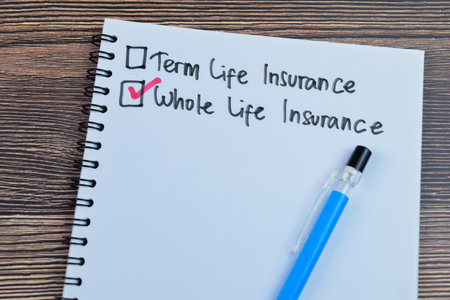 Concept of Whole Life Insurance write on book isolated on Wooden Table.の写真素材
