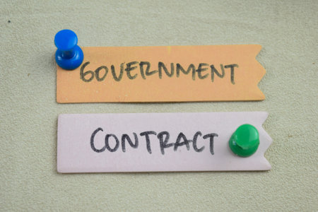 Concept of Government Contract write on sticky notes isolated on Wooden Table.の写真素材