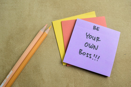 Concept of Be Your Own Bos write on sticky notes isolated on Wooden Table.