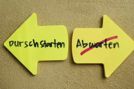 Concept of Durschstarten or Abwarten write on sticky notes isolated on Wooden Table.の写真素材