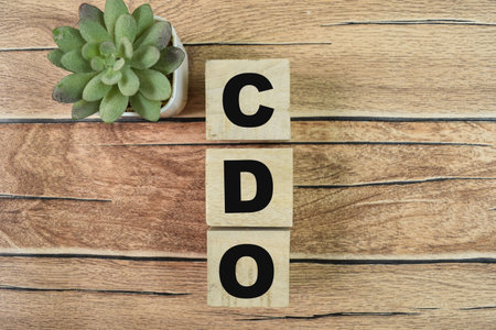Concept of The wooden Cubes with the word CDO - Collateralized Debt Obligations on wooden background.の写真素材