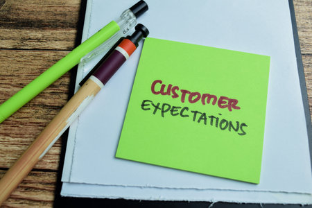 Concept of Customer Expectations write on sticky notes isolated on Wooden Table.の写真素材