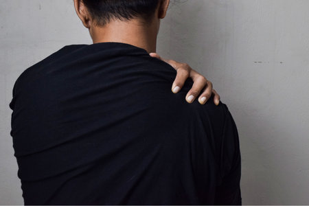 Man itching on shoulder. Medical and healthcare concept