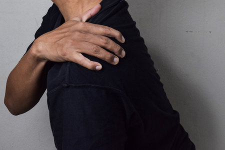 Man itching on shoulder. Medical and healthcare concept
