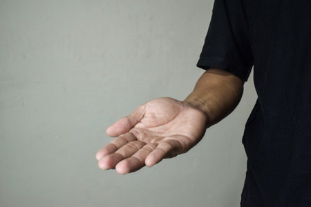 Man holds in his hands his fallen milk toothの写真素材