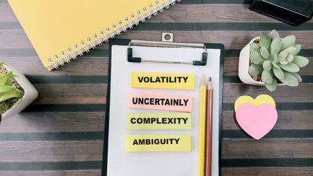 Concept of VUCA - Volatility Uncertainly Complexity Ambiguity write on sticky notes isolated on Wooden Table.の写真素材