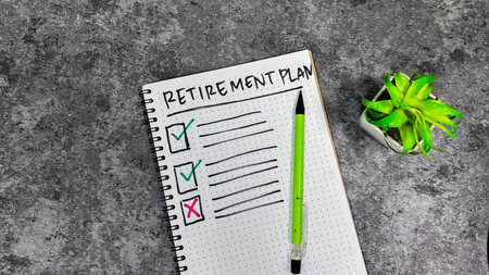 Concept of Retirement Plan write on book isolated on Wooden Table.