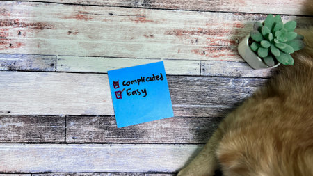 Concept of Easy or Complicated write on sticky notes isolated on Wooden Table.の写真素材