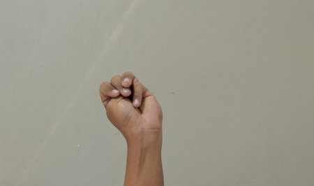 Finger spelling letter M in american sign languageの写真素材