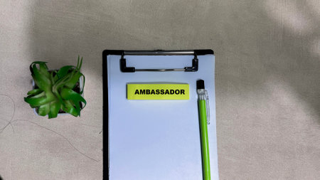 Concept of Ambassador write on sticky notes isolated on Wooden Table.の写真素材