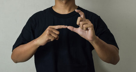 Close up Asian man shows hand gestures it means human emotion and expression using sign languageの写真素材