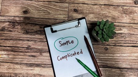 Concept of Simple or Complicated write on paperwork isolated on wooden background.の写真素材