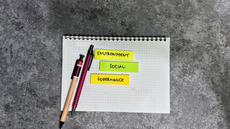 Concept of ESG - Environment Social Governance write on sticky notes isolated on Wooden Table.の写真素材