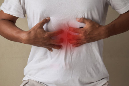 Man having gastric problems on gray backgroundの写真素材