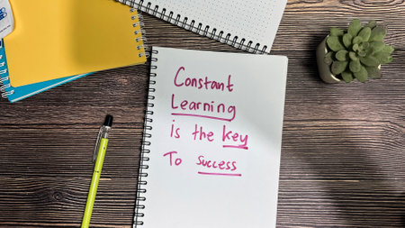 Concept of Constant Learning is the key to success write on book isolated on Wooden Table.の写真素材