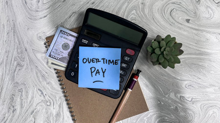 Concept of Overtime Pay write on sticky notes isolated on Wooden Table.