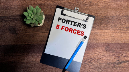 Concept of Porter's 5 Forces write on paperwork isolated on Wooden Table.の写真素材