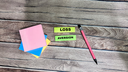 Concept of Loss Aversion write on sticky notes isolated on Wooden Table.の写真素材