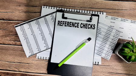 Concept of Reference Checks write on paperwork isolated on Wooden Table.