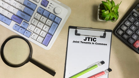 Concept of Joint Tenants in Common write on paperwork isolated on Wooden Table.