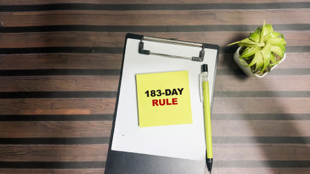 Concept of 183-day Rule write on sticky notes isolated on Wooden Table.の写真素材
