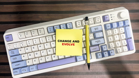 Concept of Change and Evolve write on sticky notes isolated on Wooden Table.の写真素材